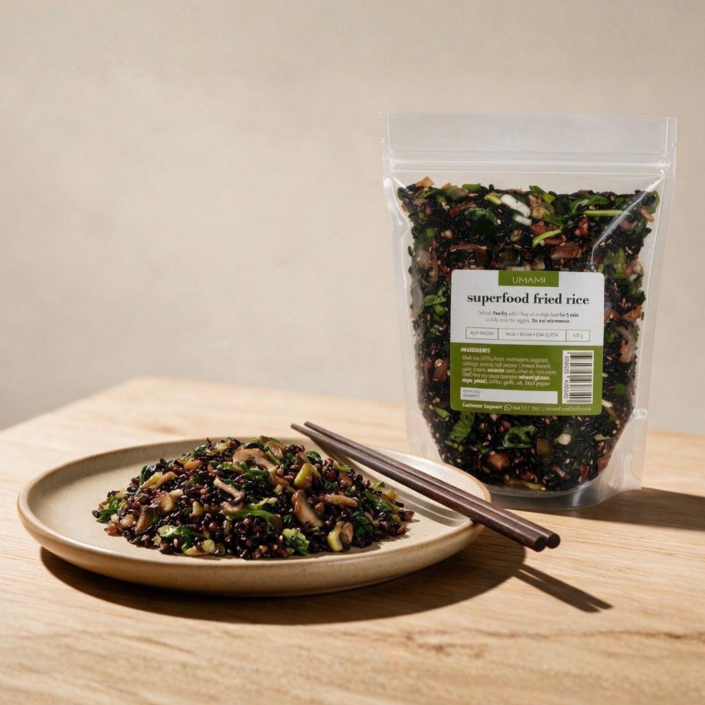 Cooked superfood fried rice served on a ceramic plate with chopsticks, next to the 450g frozen pouch