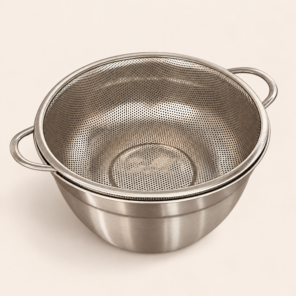 Stainless steel strainer sitting snug on its matching mixing bowl, 24cm set